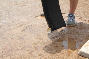 Remove puddle water without displacing infield soil