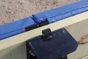Clean top edge with built-in solid batten and net cable loop on the slide-over post bracket.